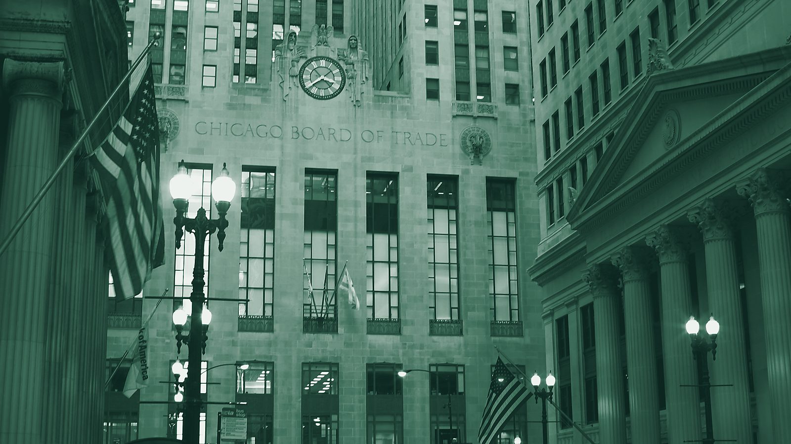 The Art Deco Chicago Board of Trade building at the end of a street lined with flags